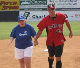 Crawdads Pitcher Joe Wieland and a member of the Rangers run the bases during the 15th annual Walkin' Roll All-Star Game at L.P. Frans Stadium on Saturday, June 20.